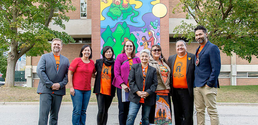 group photo in front of the library mural