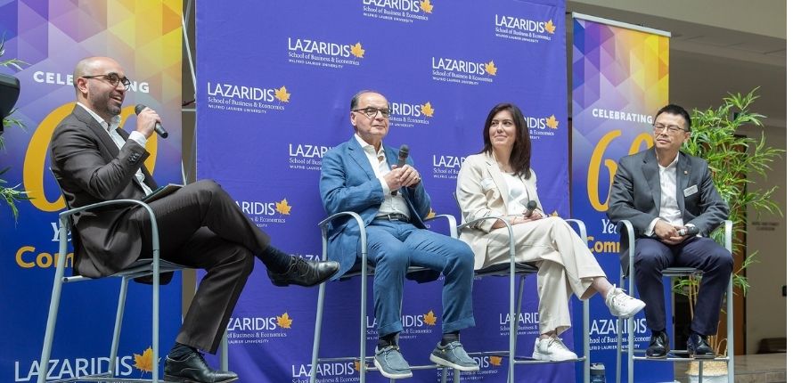 Brandon Mattalo speaks into microphone as other panellists smile