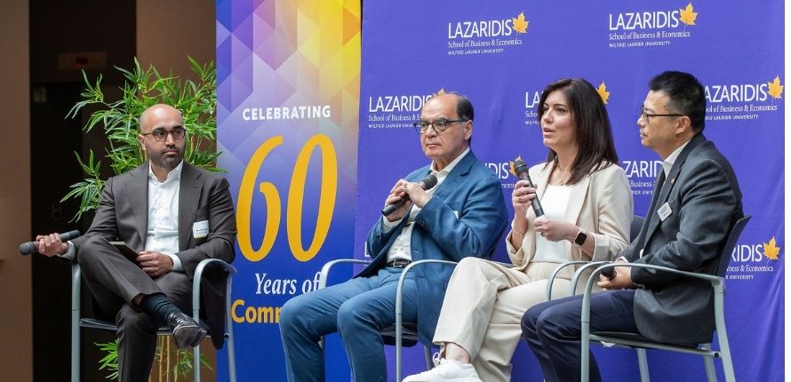 Rima Khatib speaks into the microphone as other panellists look on