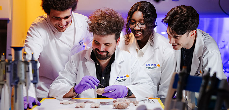Nicolas Rouleau and students working in a lab