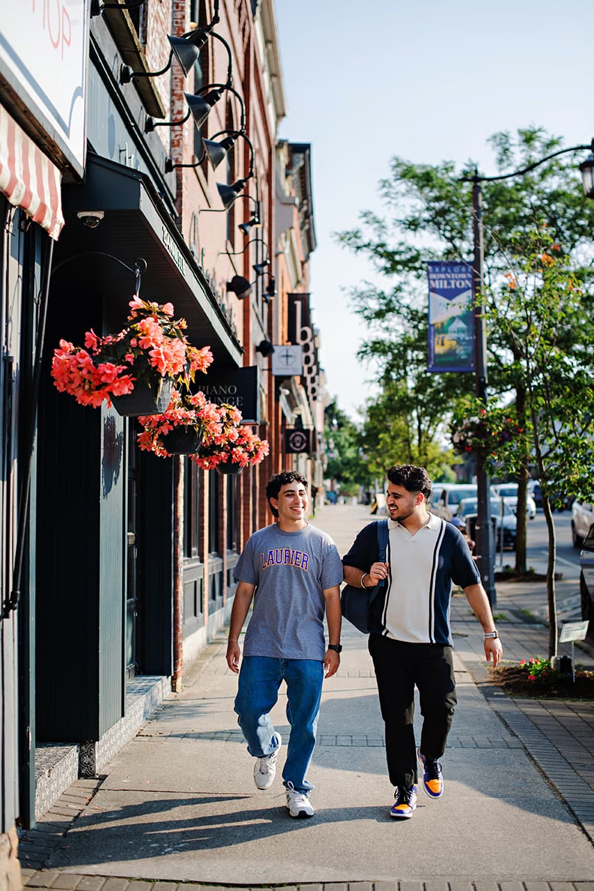 Students walking along a downtown Milton sidewalk