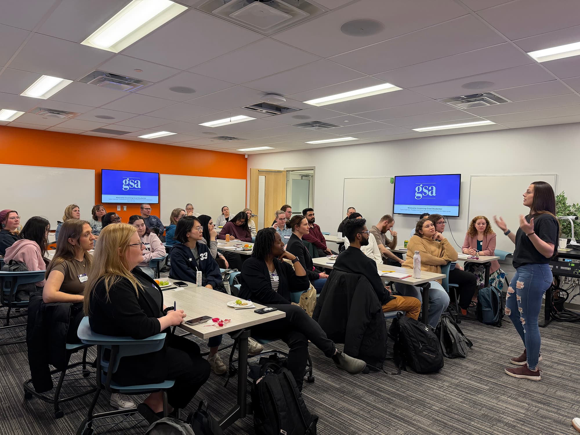 Groups of students listening to a GSA presentation