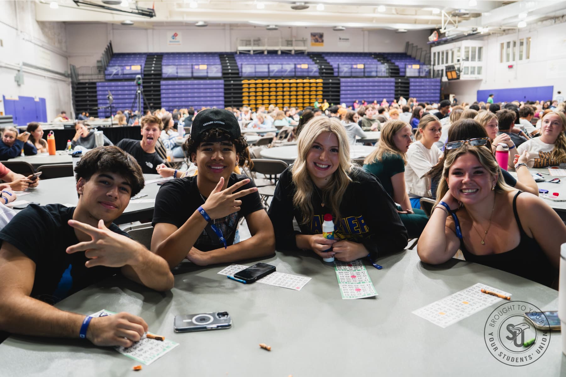 Students playing bingo in university stadium