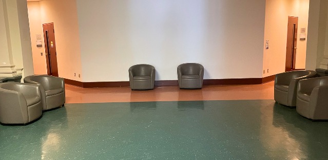 Foyer with lounge chairs lining three walls