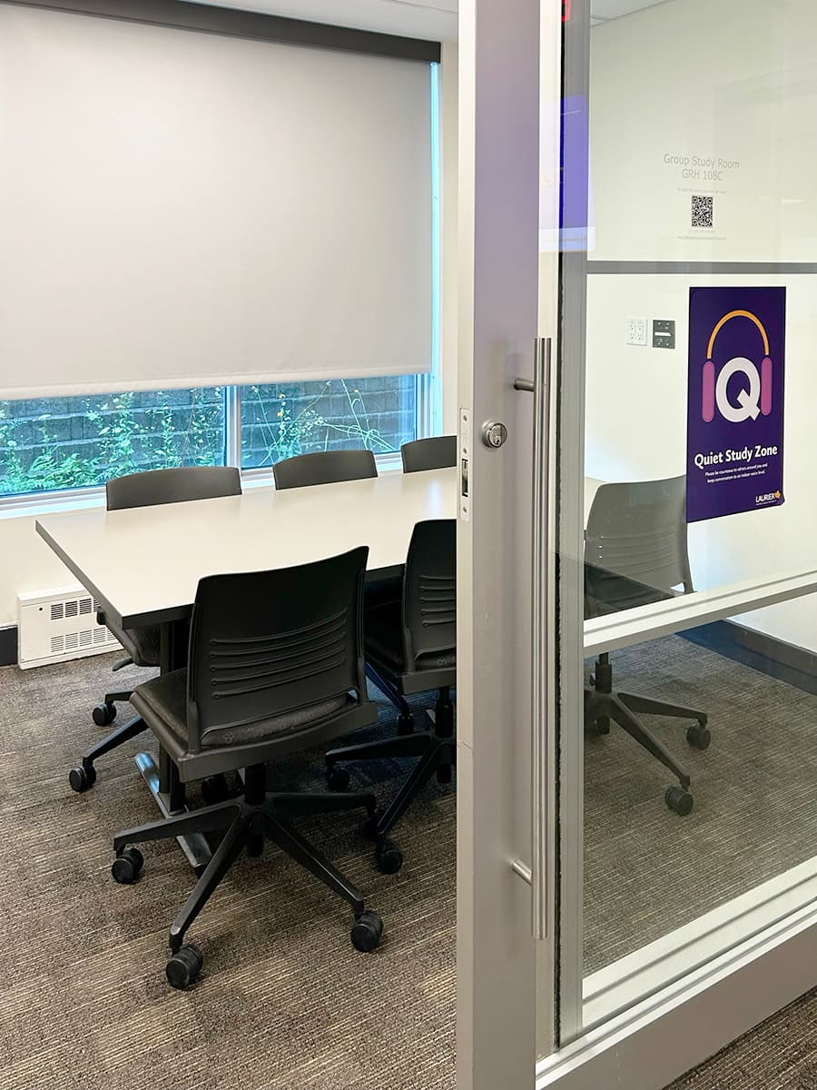 Desk seating in a small room with a sliding glass door and a window