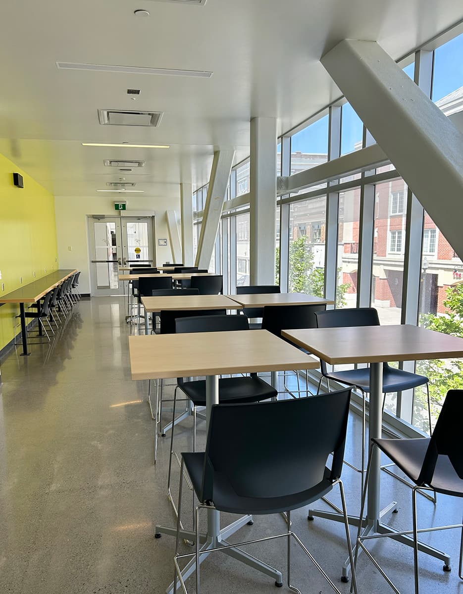 Rows of desk seating along a wall of windows