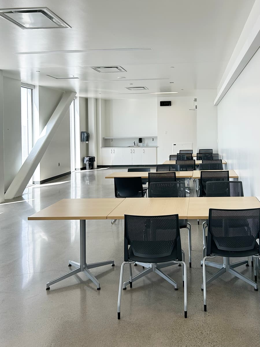 Rows of desk seating in front of a small kitchenette