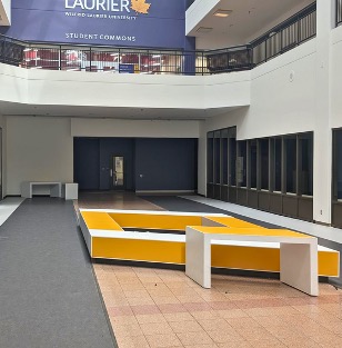 Bench seating on the lower level beneath a balcony