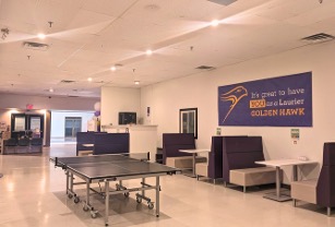 Ping pong table next to a row of booth seating against a wall