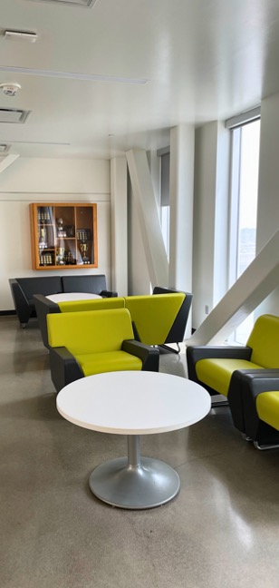 Lounge chairs in a corner in front of display case