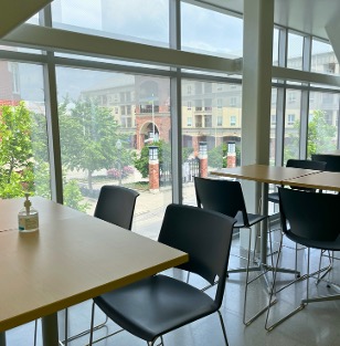 Two tables in front of a large window