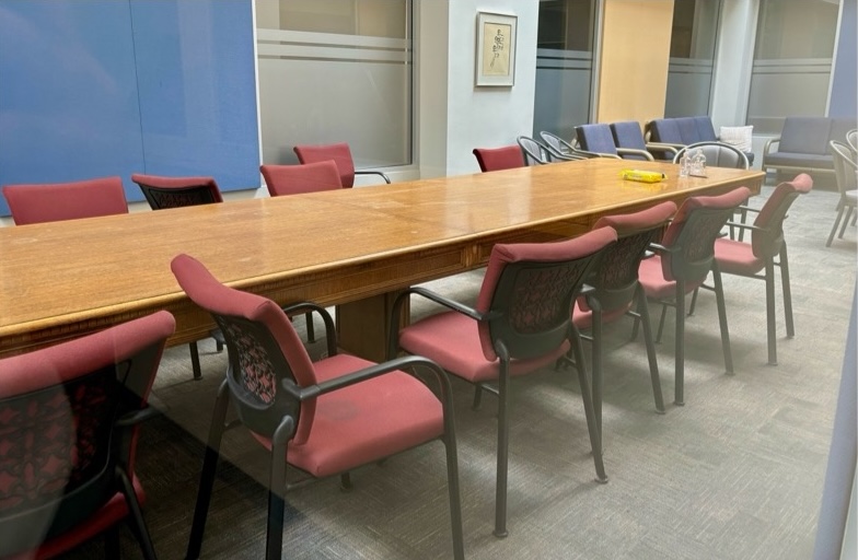 Room with long table in the centre and lounge seating