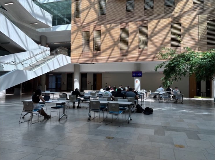 Open floor space with tables and a large staircase in the background