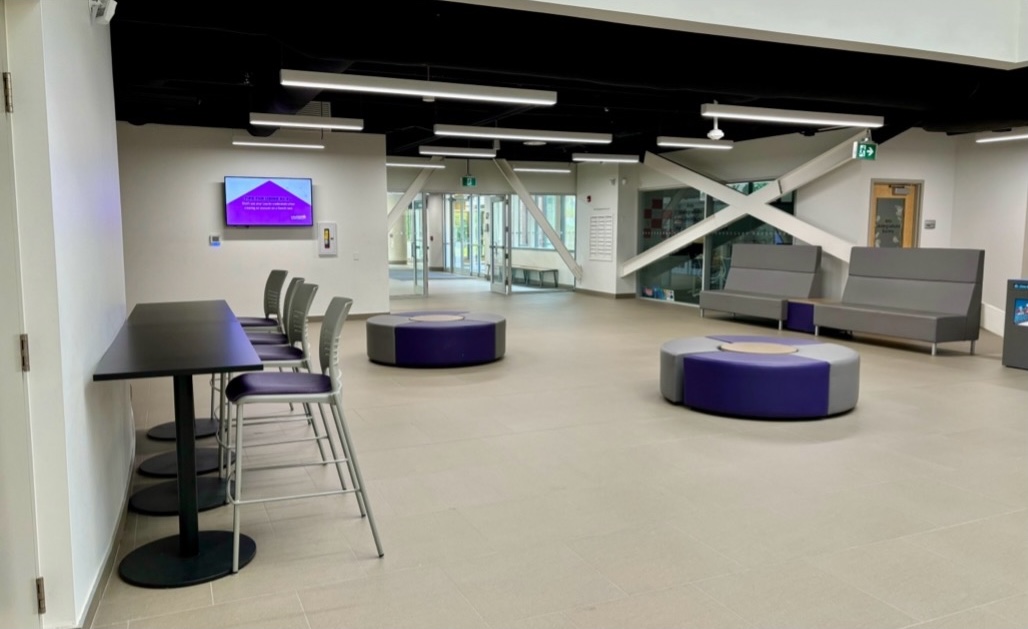 Foyer with bench seating and a long table facing a wall
