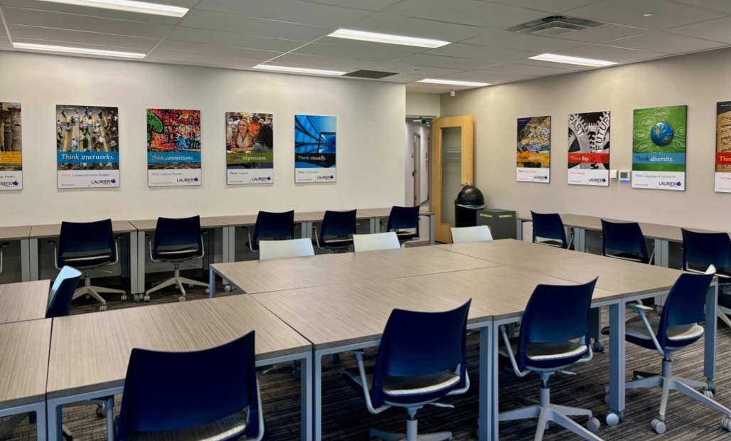 Room full of rows of desk in the centre and facing the walls