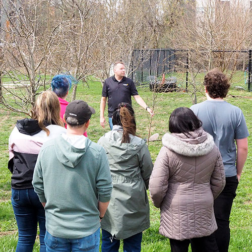 James Emery explaining tree planting to group