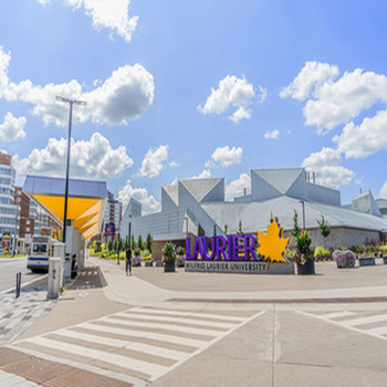 Laurier sign in front of white and brown building on the Waterloo campus