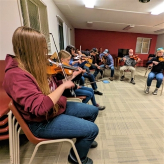 Students participating in a fiddle jam