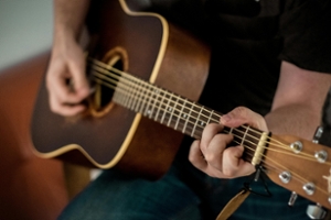 Photo of person playing guitar