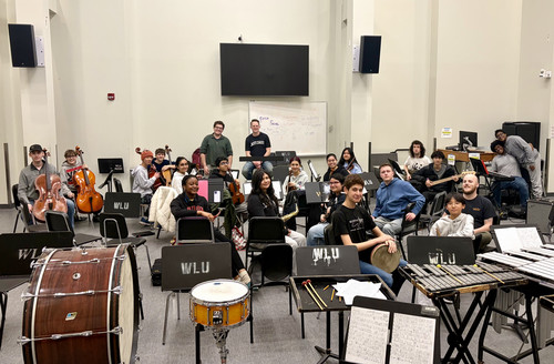 Members of NextGen Youth Orchestra posing with their instruments