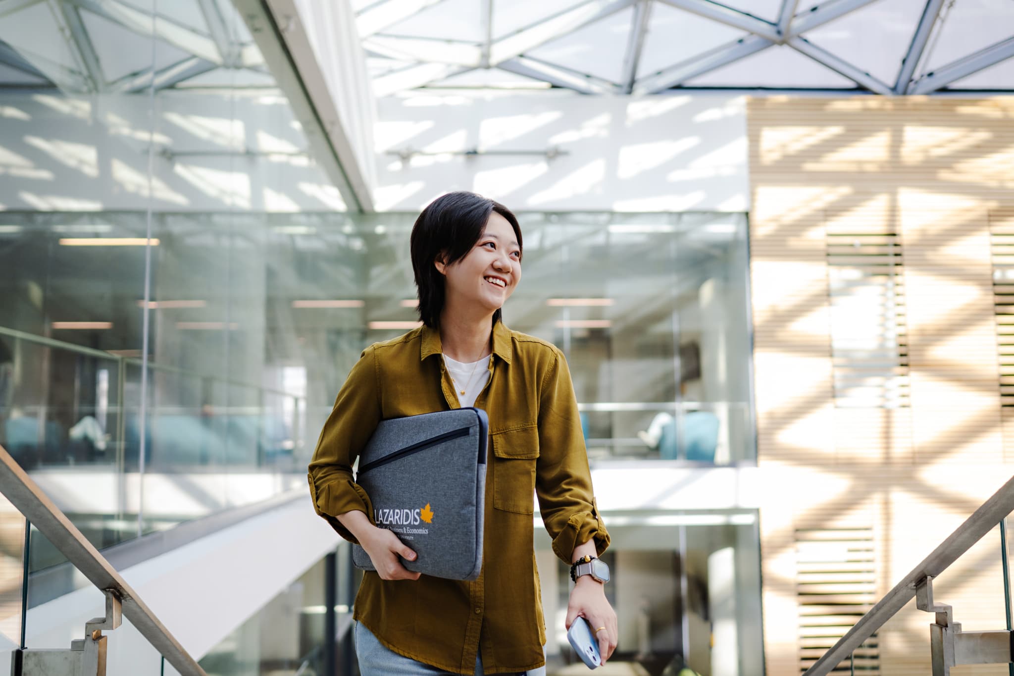 Female student walking up the stairs in Lazaridis Hall