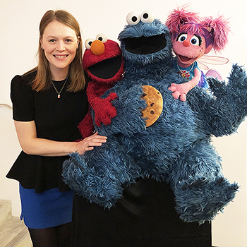 Natasha Babcock with Sesame Street characters.