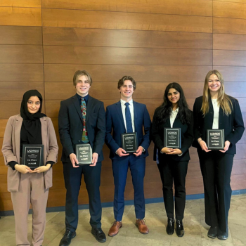 Winning team standing with their plaques. 