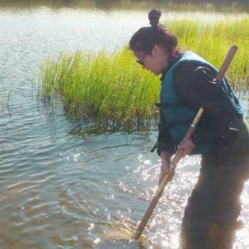 thumbnail of a student collecting samples in water