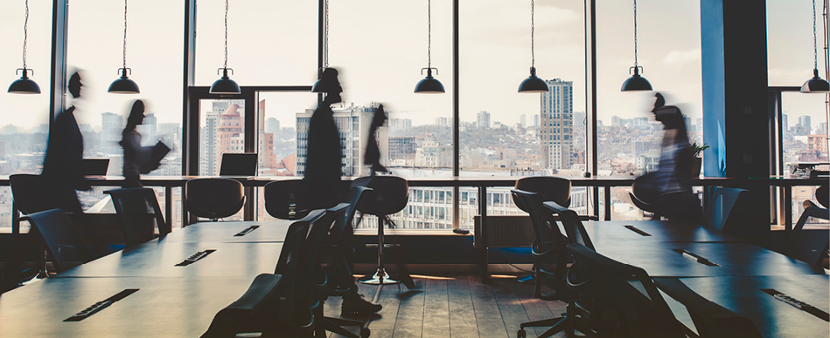 office space with blurred workers walking by