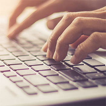 hands typing on a keyboard