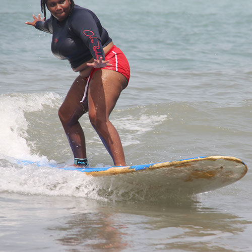 Young woman surfing in the ocean
