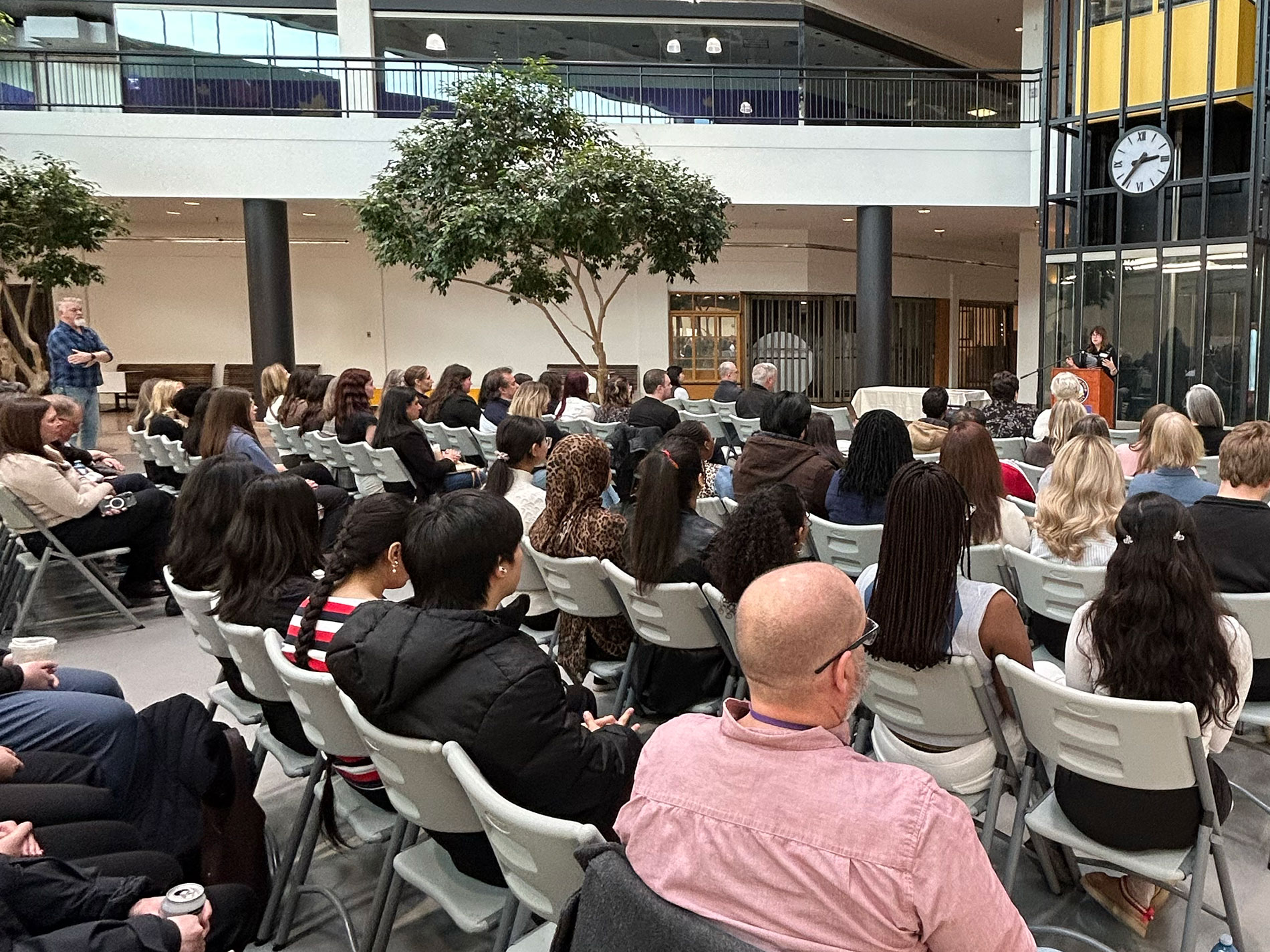 A large seated audience in Laurier Brantford's One Market atrium