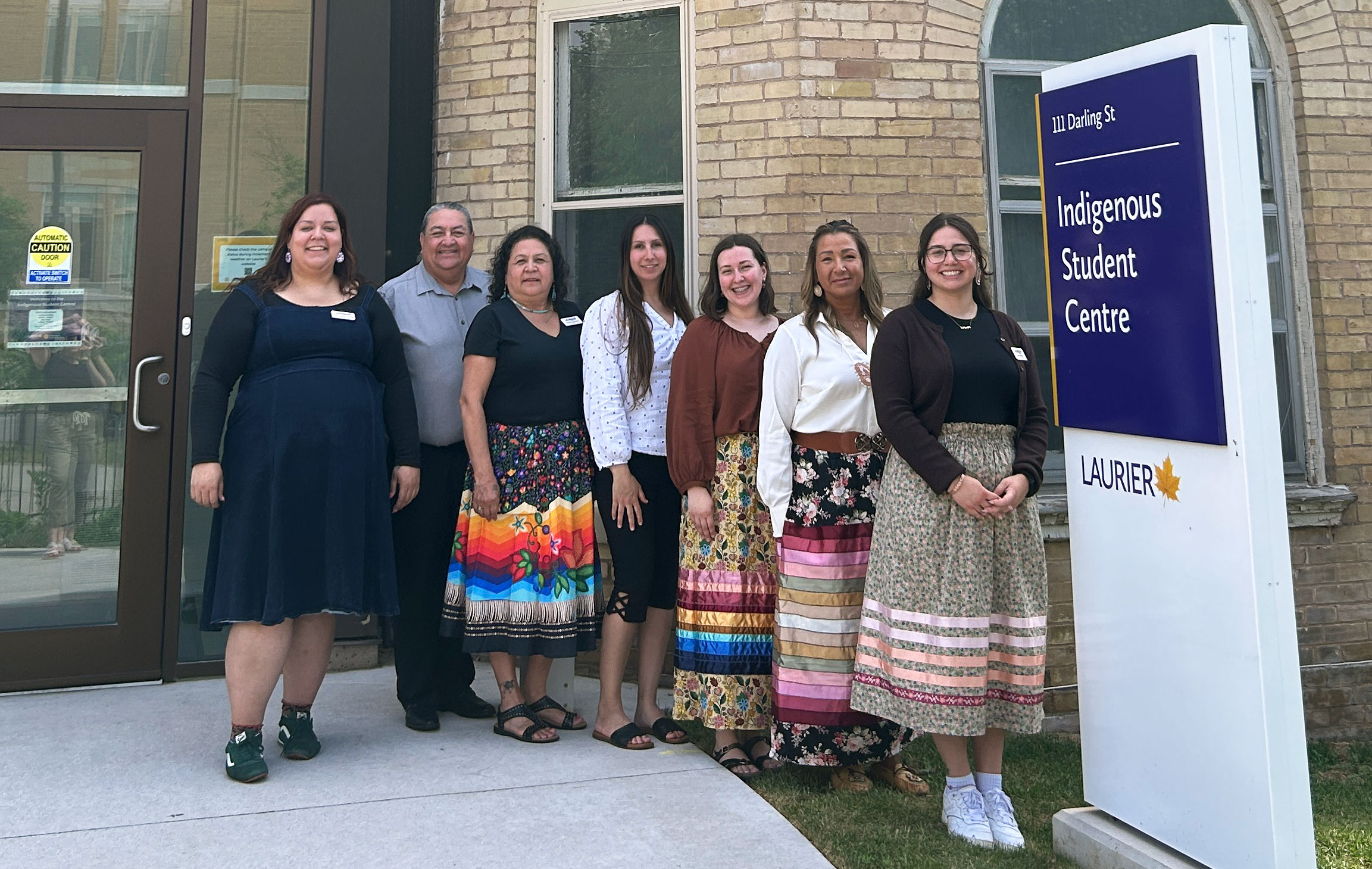 Staff stand in front of Laurier's Brantford campus Indigenous Student Centre