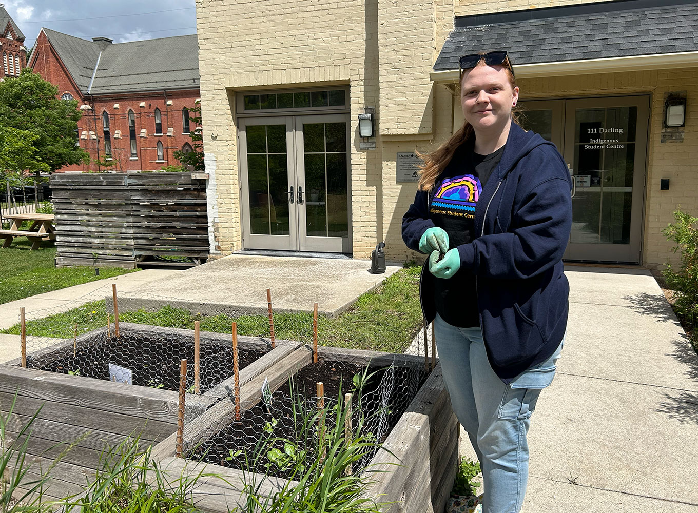 Sam Lewis tends the Indigenous Student Centre medicine garden