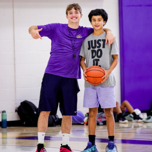 Coach and camper at basketball camp