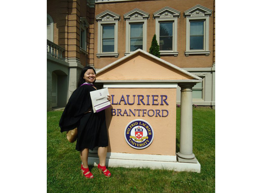 Rachel Phan stands in front of Laurier Brantford's Carnegie Building at convocation