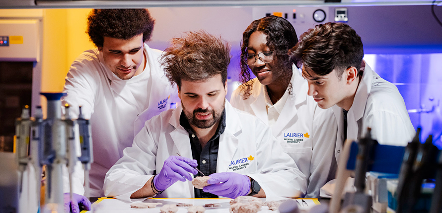 Professor and students work in a lab