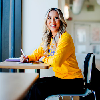 Student working and smiling at camera