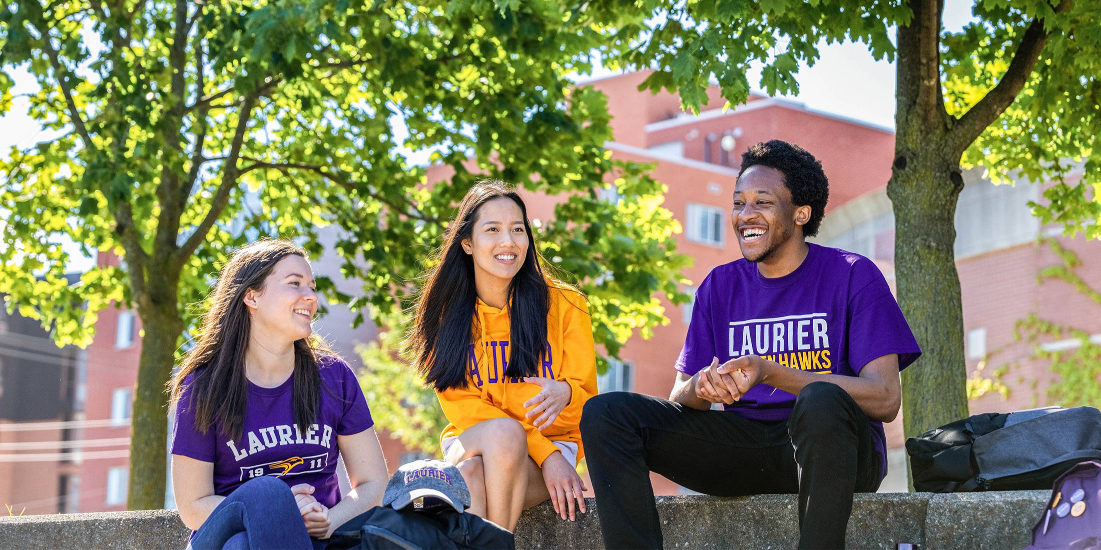 Three students enjoying campus outsite