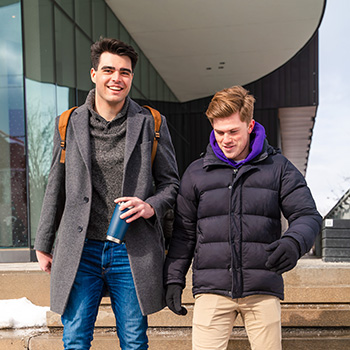 two male students outside of lazaridis building in winter