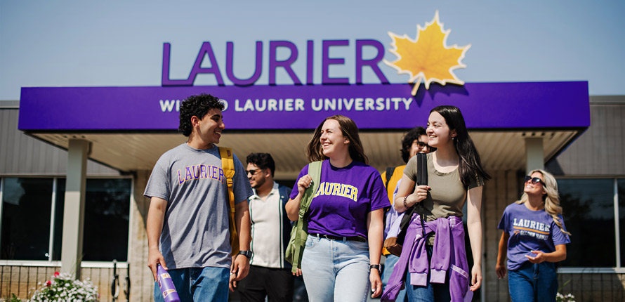group of students walking in front of milton building