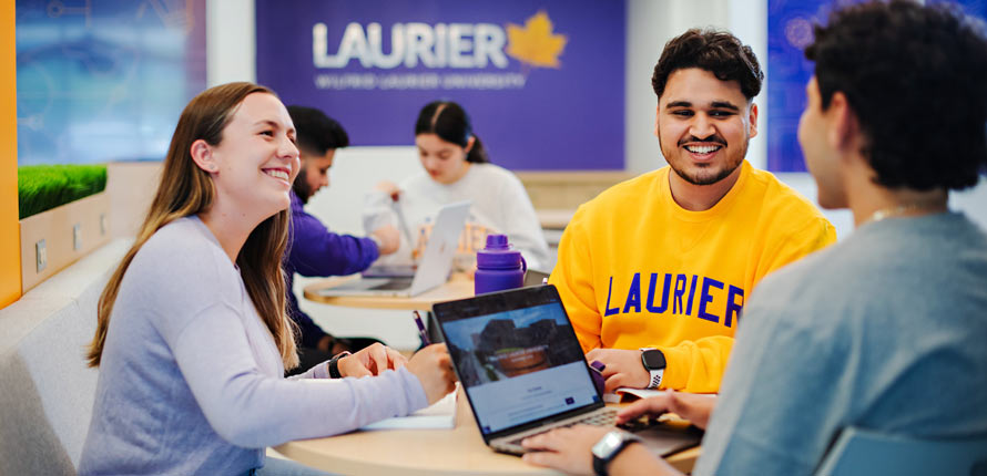 three students sitting inside at laurier milton