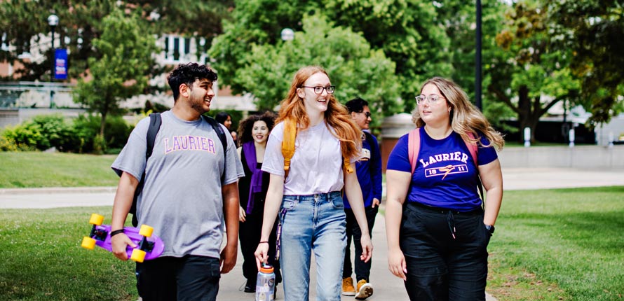 Laurier students walking on Waterloo campus in summer