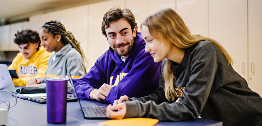 students look at computer