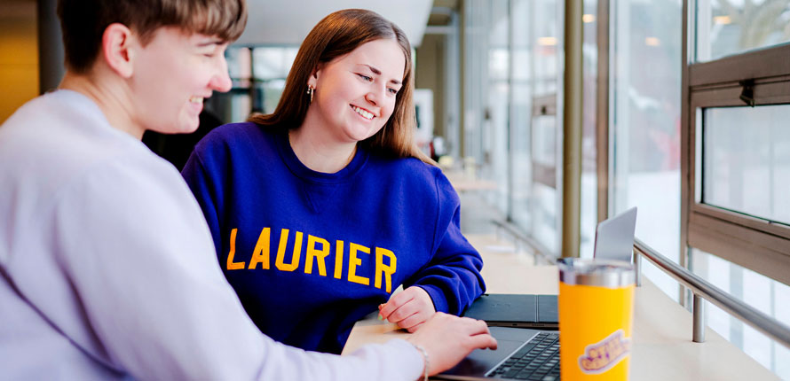 student helps peer with studying