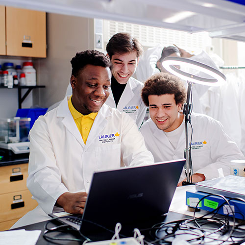 three students in a lab