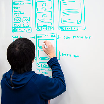 A student maps out a problem on a whiteboard.