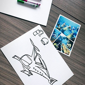 Image of a playing card, paper and markers.