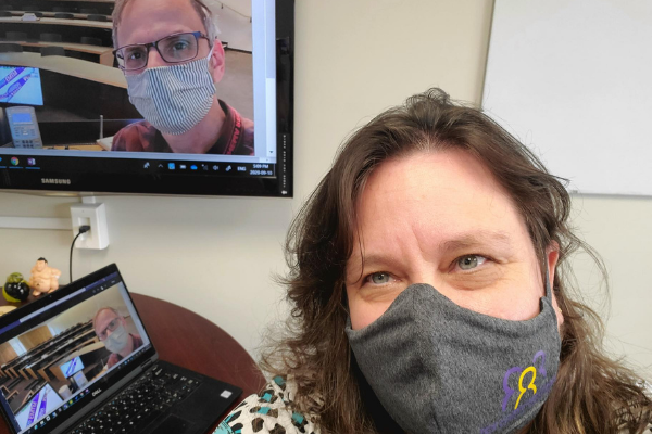 Man and woman wearing masks