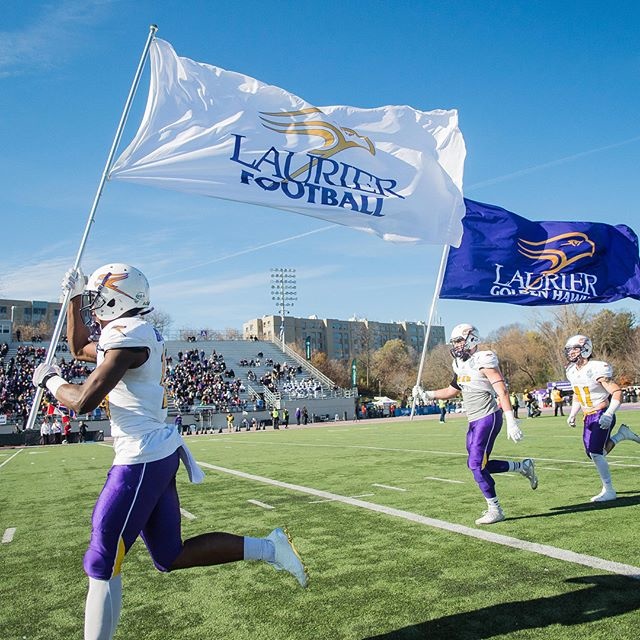 Football players carry flags